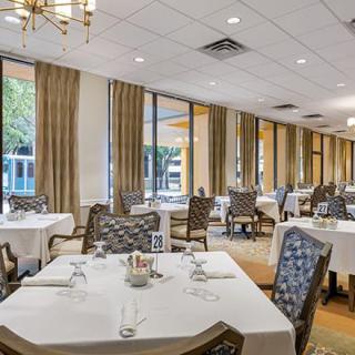 Elegant dining room with neatly arranged tables and large windows.