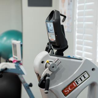 A SCIFIT exercise machine in a gym setting, used for fitness and rehabilitation.