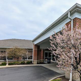 An inviting entrance to a building adorned with blooming flowers in spring.