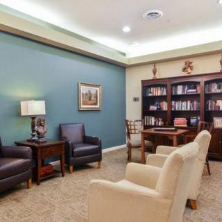 Cozy library with a comfortable seating area and bookshelves.