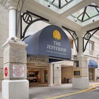 The entrance of The Jefferson hotel with a large canopy overhead.