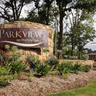 Entrance sign for Parkview on Hollybrook surrounded by landscaped plants.