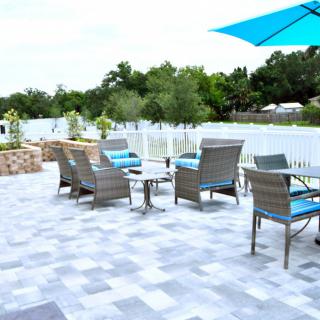 A serene patio area with stylish seating and a beautiful lake view.