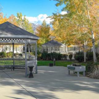 A peaceful park scene with a gazebo surrounded by autumn trees.