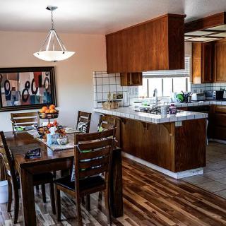 Contemporary dining room and kitchen area with wood finishes and stylish decor.