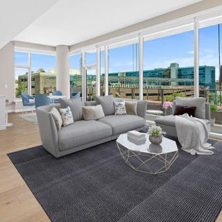 A bright and modern living room featuring stylish furniture and a beautiful view.