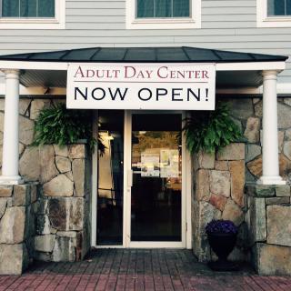 Entrance of an Adult Day Center with a 'Now Open' sign.