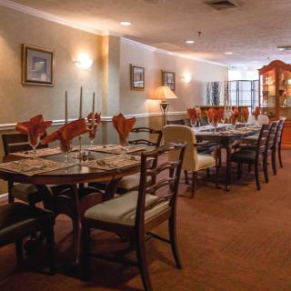 A cozy and elegant dining area in a restaurant with neatly arranged tables and chairs.