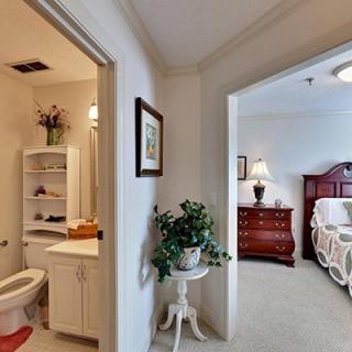 View of a bedroom and bathroom in a cozy home setting.