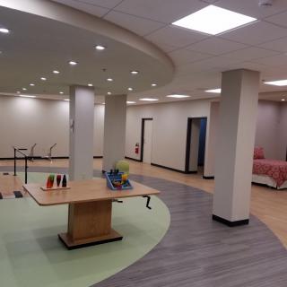 An empty retail space with display tables and bright lighting.