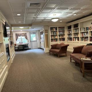 A cozy reading area featuring bookshelves and comfortable seating.
