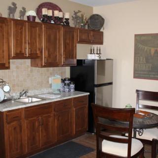 A cozy kitchen with wooden cabinets and a small dining area.