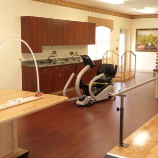 A physical therapy room equipped with exercise machines and rehabilitation equipment.