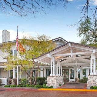 A welcoming entrance to a building surrounded by trees.