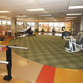 Interior of a fitness center with exercise equipment and rehabilitation tools.