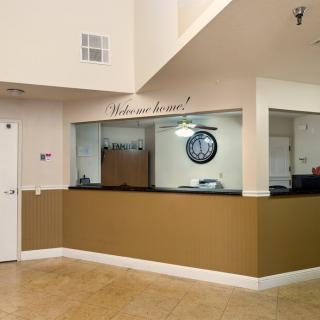 A welcoming office reception area with a desk and a 'Welcome' sign on the wall.