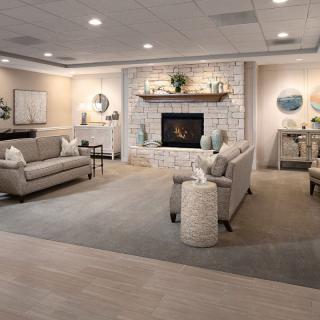 A modern and cozy living room with a stone fireplace, stylish furniture, and tasteful decor.