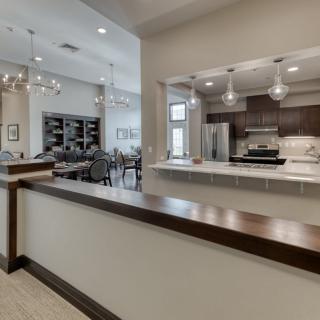 A modern open-concept kitchen and dining area with stylish lighting.