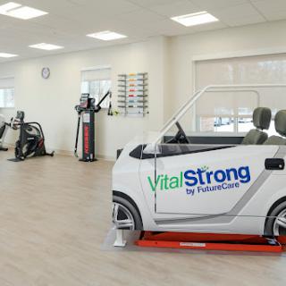 A modern rehabilitation center featuring exercise equipment and a specialized vehicle for therapy.