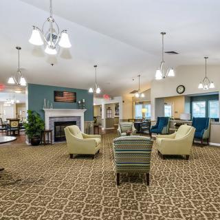 A spacious and well-lit lobby area with comfortable seating and a decorative fireplace.