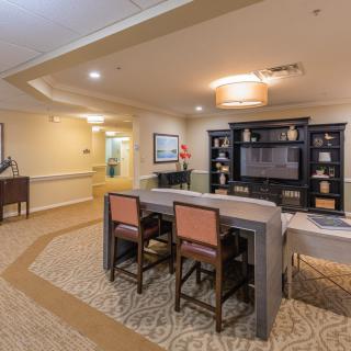 A cozy living space with a dining area and shelves for decor.