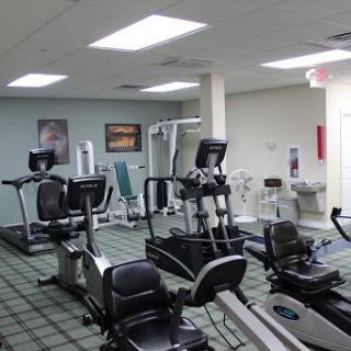A well-equipped indoor gym featuring various exercise machines for cardiovascular workouts.