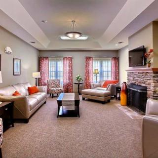 A cozy living room with modern furniture and a fireplace.