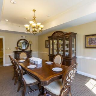 A well-decorated dining room with a wooden table, chairs, and a chandelier.