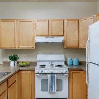 A well-organized kitchen with wooden cabinets and modern appliances.