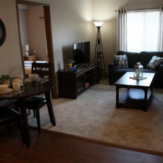 Cozy living room with a sofa, coffee table, and television.