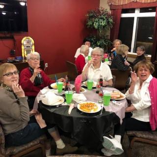 A group of friends enjoying a meal together in a cozy indoor setting.