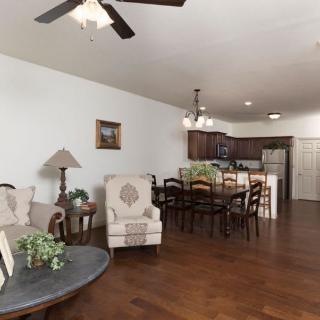 An open-concept living and dining area with hardwood floors and a view into the kitchen.