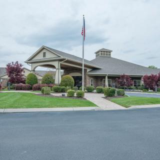 A well-maintained building with a flagpole and landscaped surroundings.
