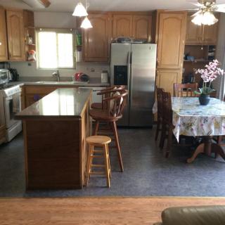 A cozy kitchen with an island counter and dining area.