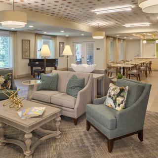 A cozy and elegant living room with comfortable seating and soft lighting.