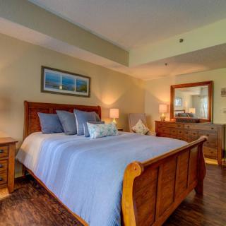 A cozy bedroom with a wooden bed and elegant decor.