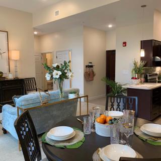 A modern open-concept living space featuring a cozy dining area, stylish kitchen, and elegant decor.