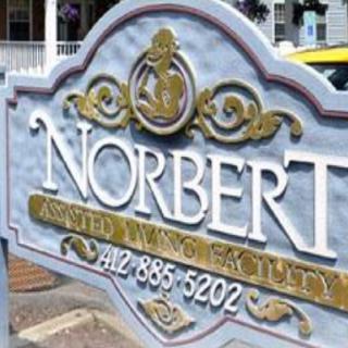 A business sign displaying the name 'Norbert' with a phone number.