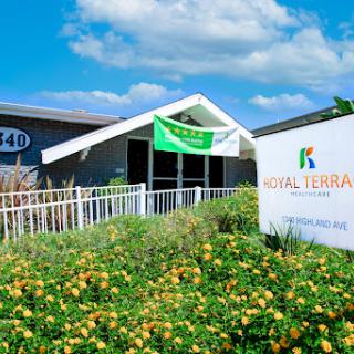 A vibrant library building surrounded by blooming flowers, showcasing a welcoming atmosphere.