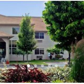 A scenic view of a building surrounded by lush greenery and trees.