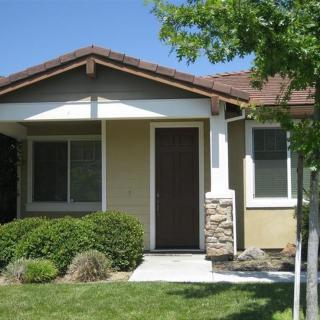 A small suburban house with a neatly maintained front yard.