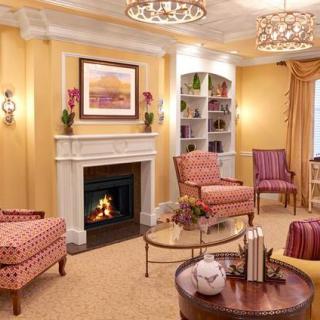 A cozy living room with traditional decor, featuring a fireplace and comfortable seating.