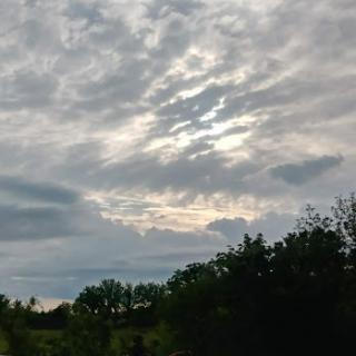 A serene view of a cloudy sky, blending shades of gray with hints of light.