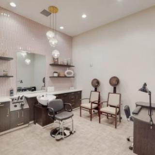 A well-equipped salon interior with styling station and seating.