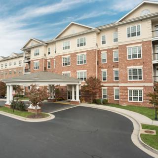 A multi-story residential apartment building with a covered entrance.
