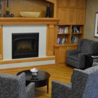 A cozy living room with a fireplace and comfortable seating.