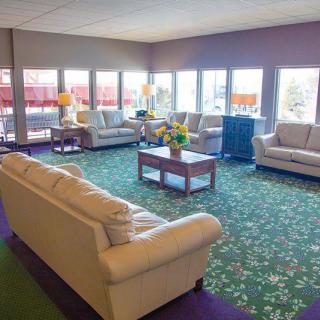 A spacious lobby with comfortable sofas and large windows.