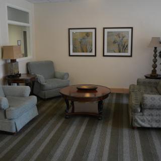 A cozy living room featuring comfortable seating and decorative wall art.