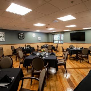 A cozy dining area with elegantly set tables and a warm ambiance.