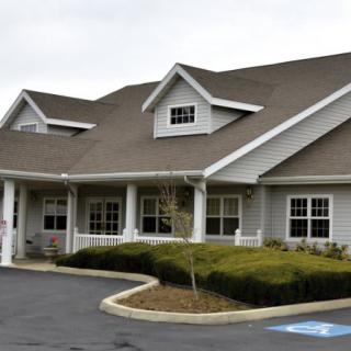 A modern building with a landscaped front and accessible parking space.
